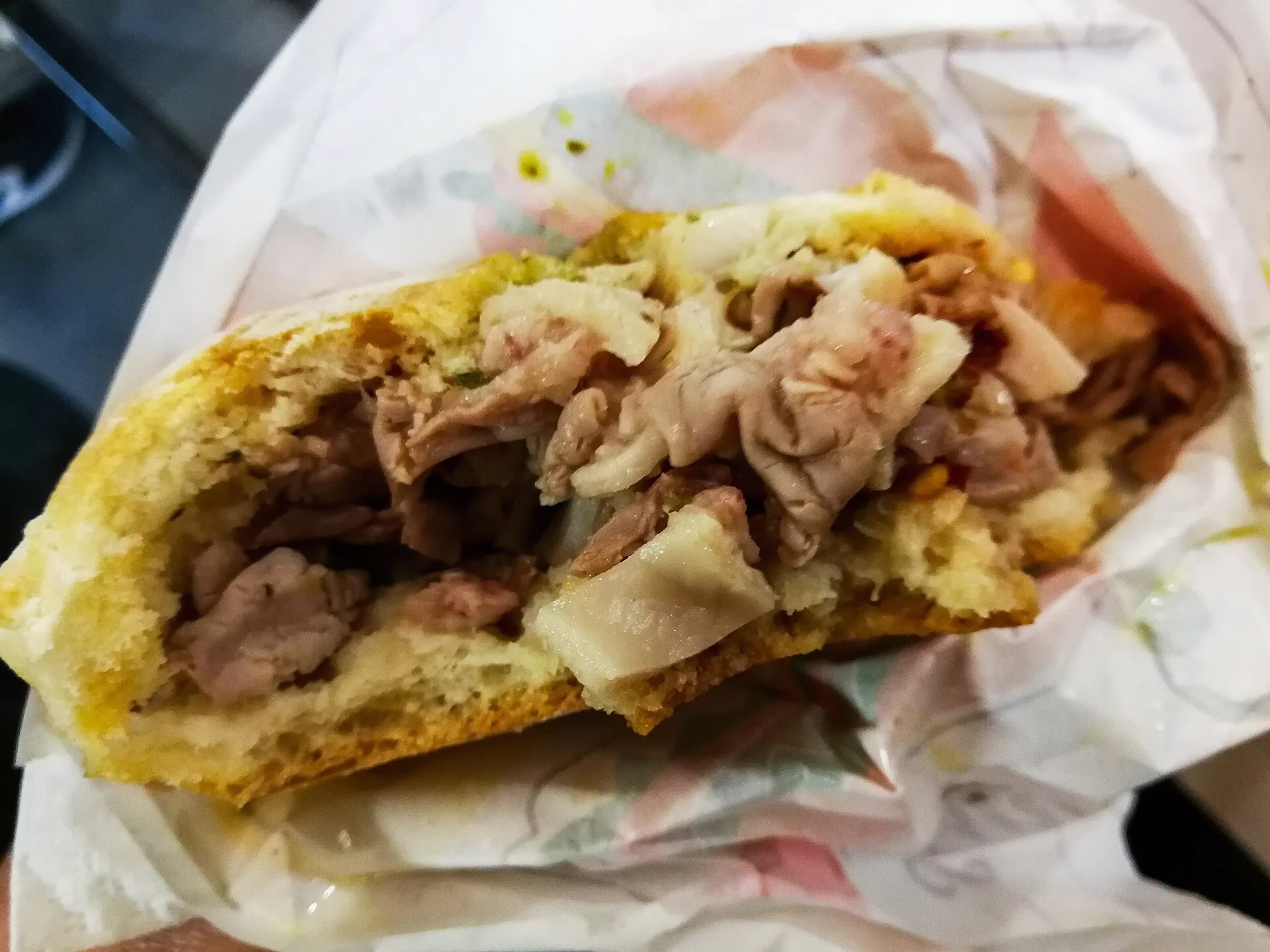 A panino filled with lampredotto, a Florentine sandwich made with boiled beef offal.