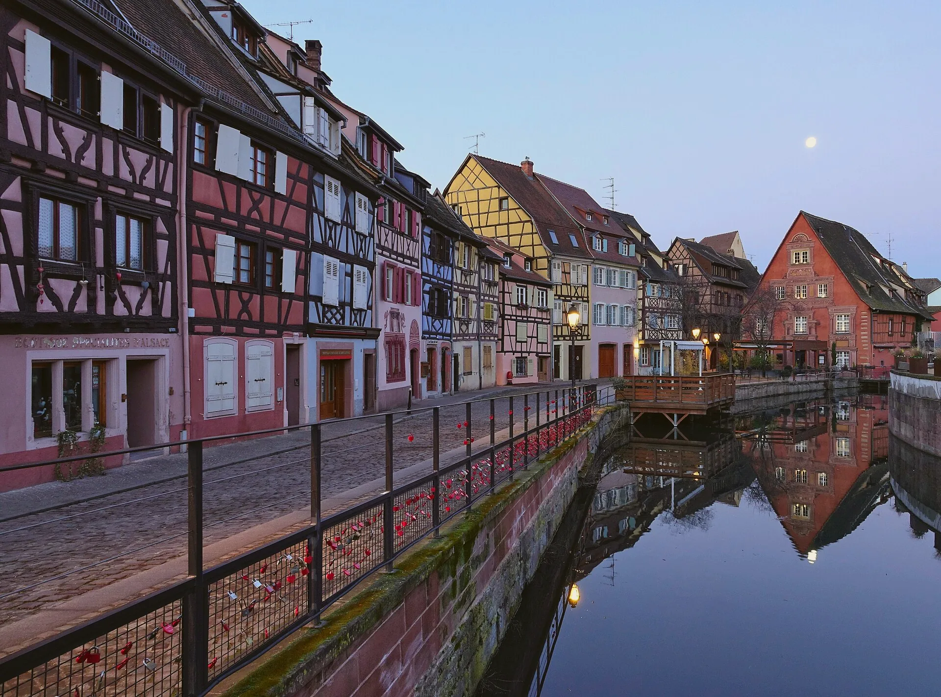 Half-timbered houses beside the canal at Petite Venise in Colmar, viewed from a bridge.
