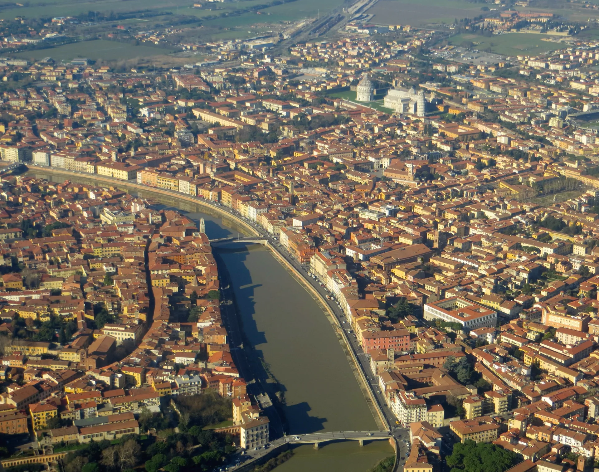 Aerial view across Pisa, with the Arno running through the city.
