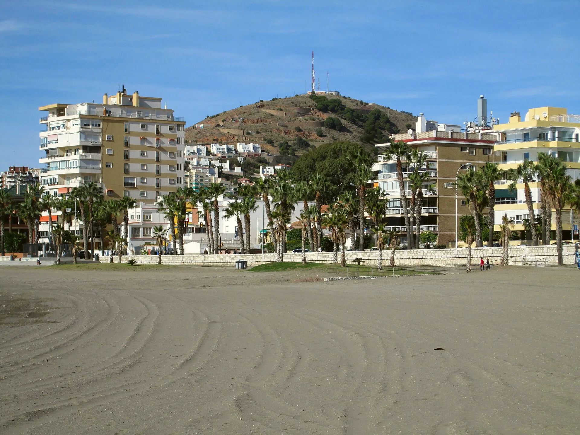 Playa de la Caleta with Monte Victoria rising behind it in Málaga.