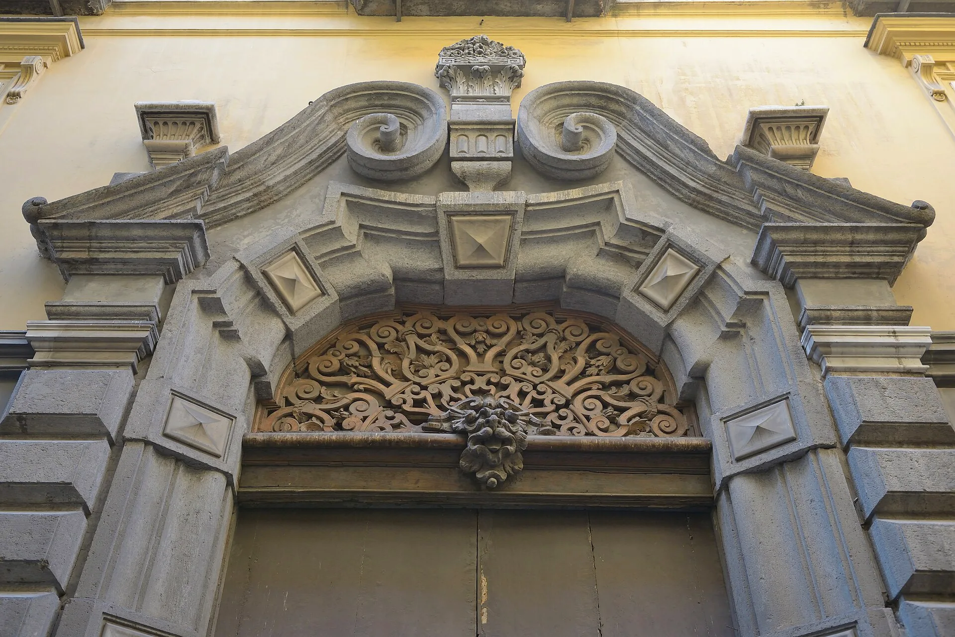 A stone portal set into a building on Via Benedetto Croce, viewed from Via Santa Chiara.