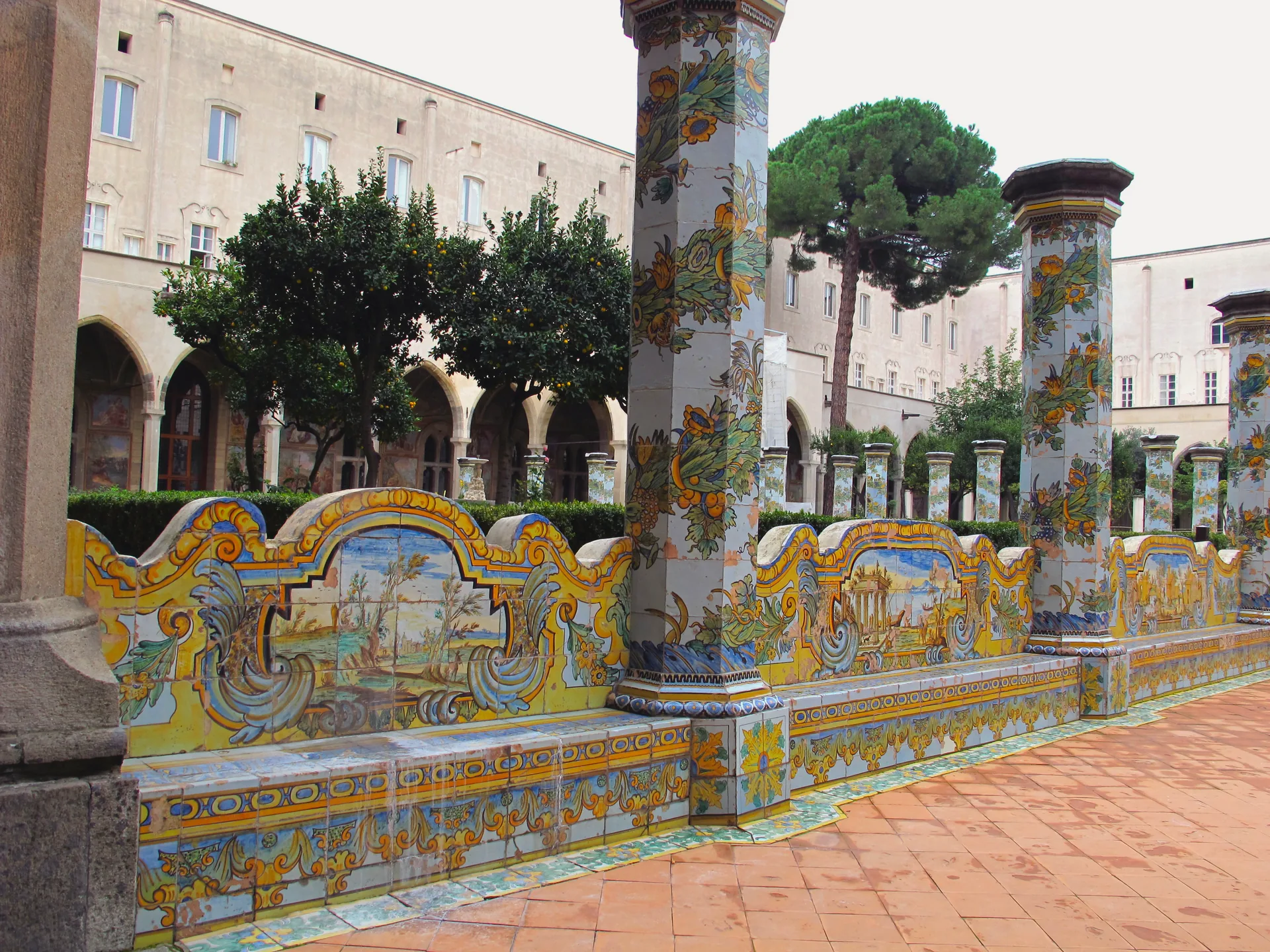 The tiled cloister of Santa Chiara, with majolica decoration and garden walkways.