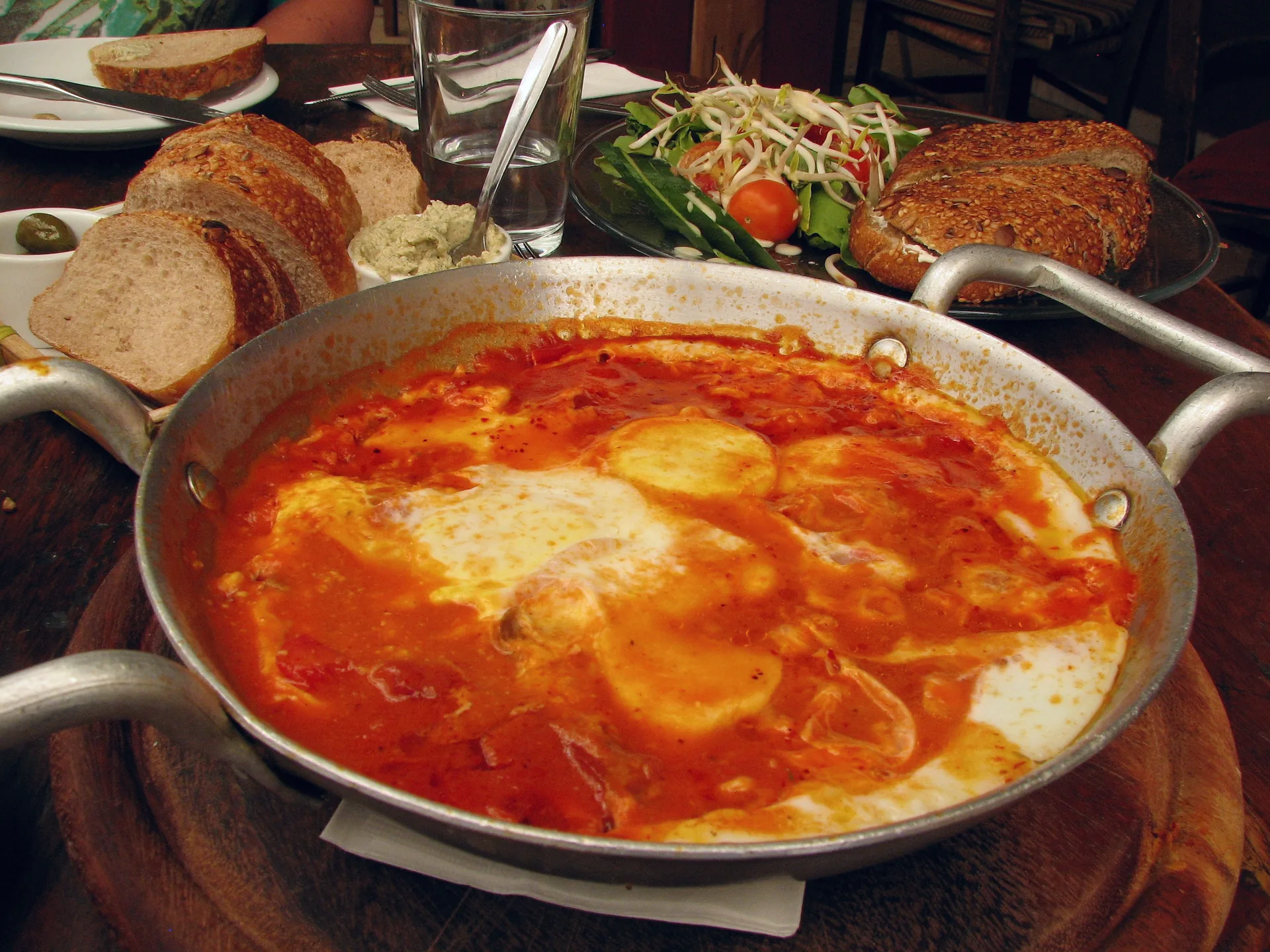 Eggs poached in tomato sauce in a pan of shakshuka.
