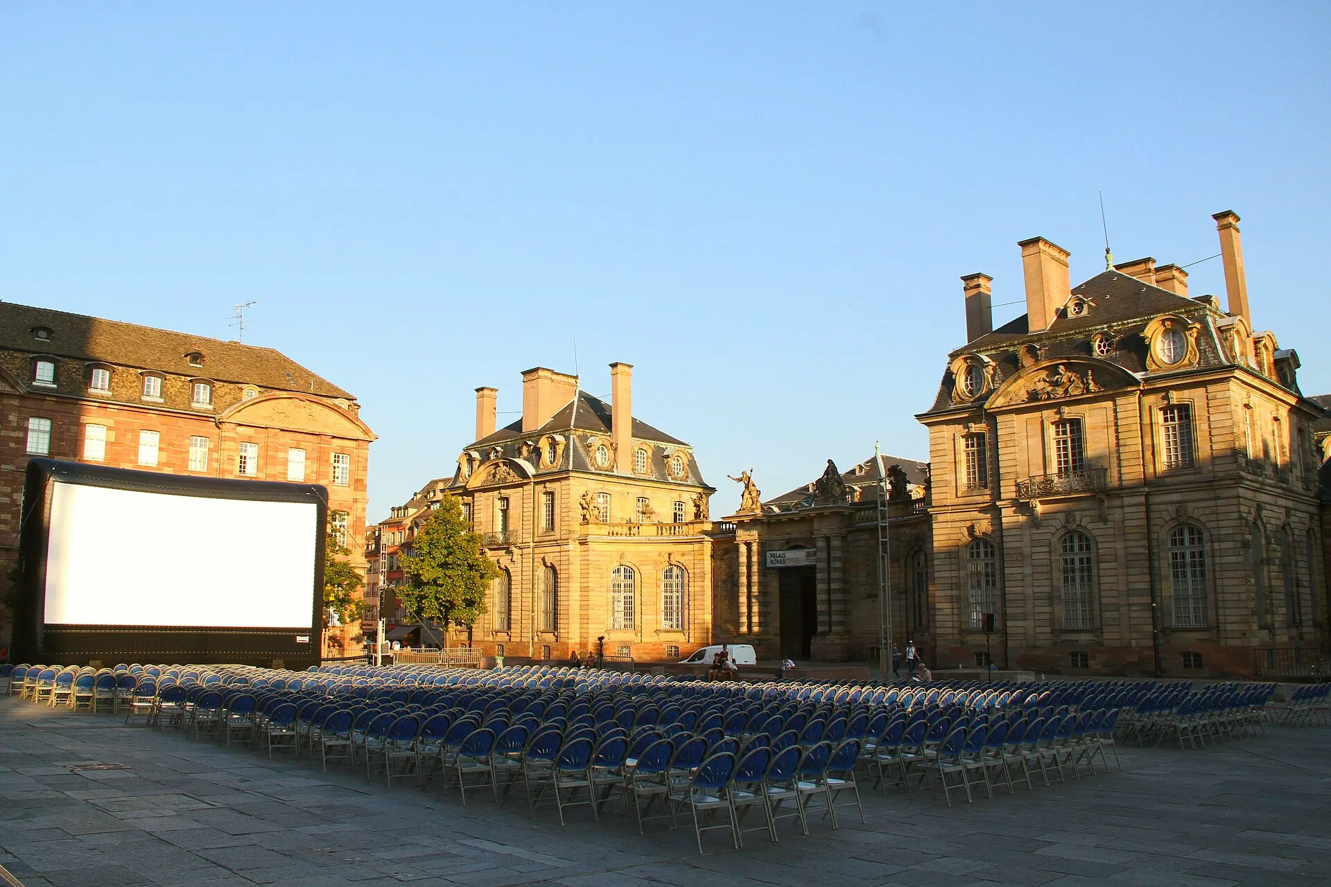 Rows of chairs face a large outdoor cinema screen in Place des Rohan.