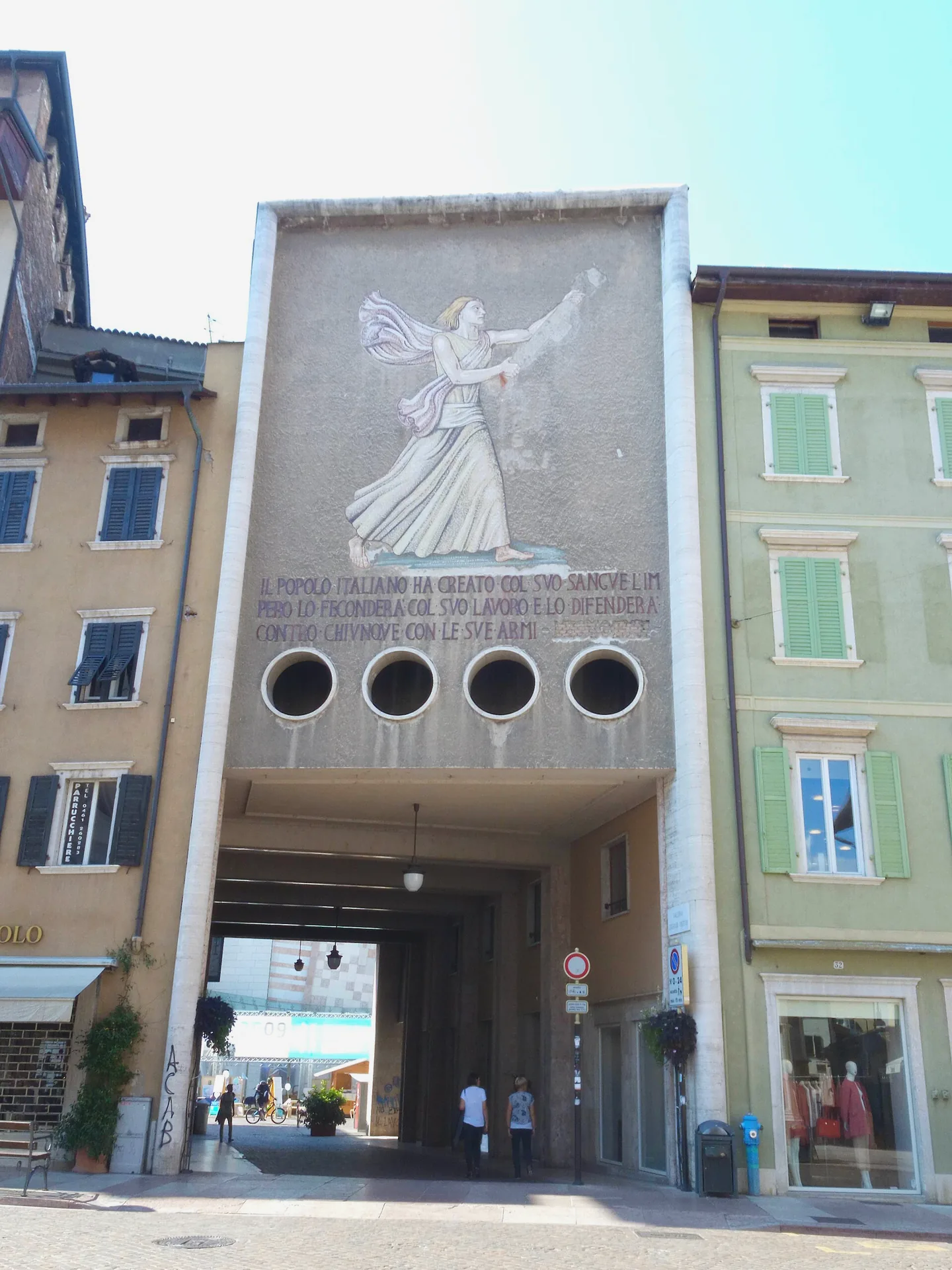 The covered Legionari Gallery in Piazza Cesare Battisti, with decorative features along the passage.