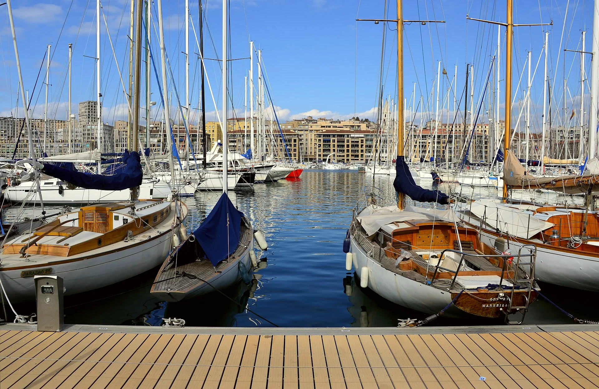 Boats moored in Marseille’s Vieux-Port, with buildings along the waterfront.