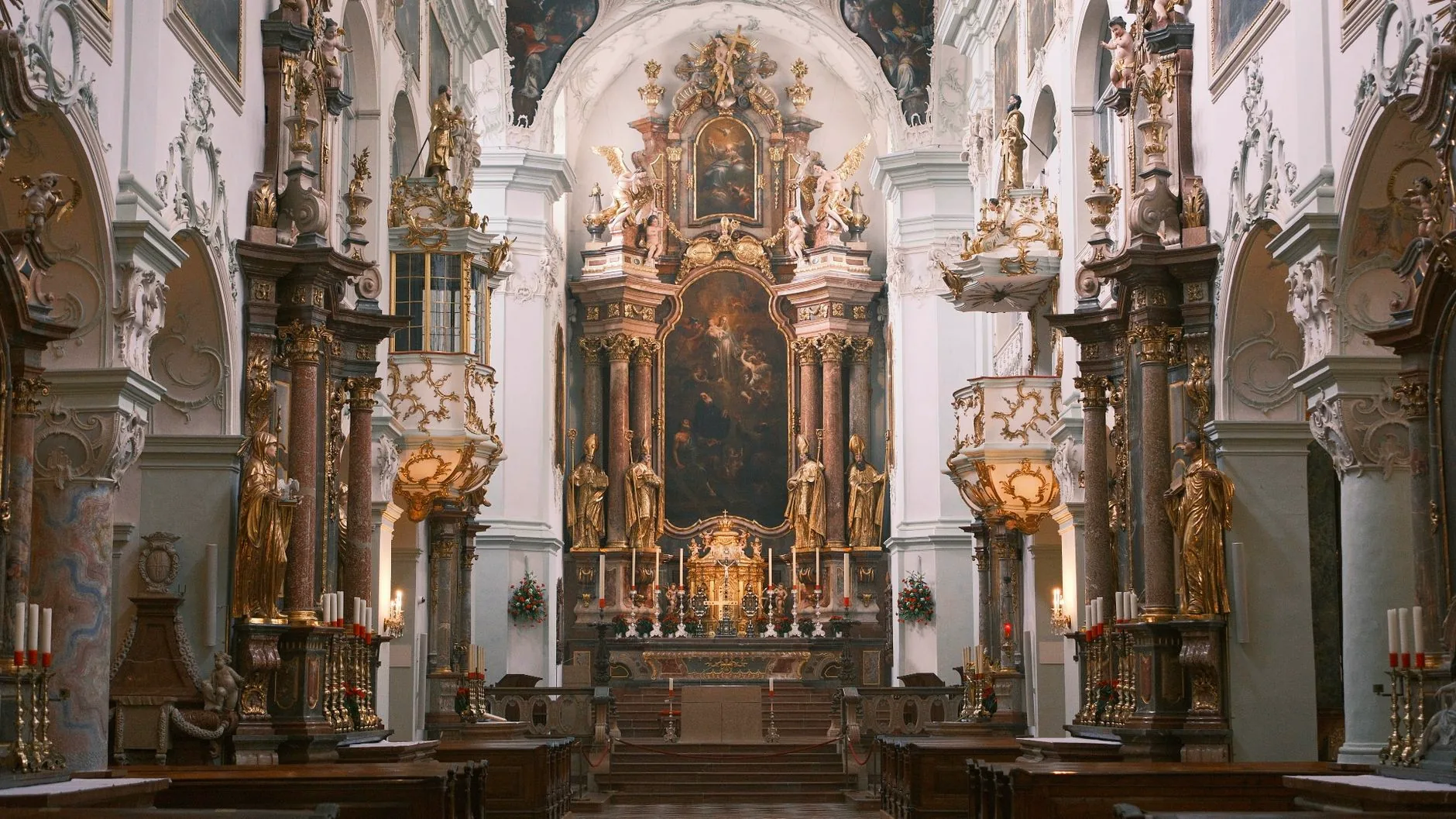 Ornate altar and sculptures inside a Baroque church in Vienna.
