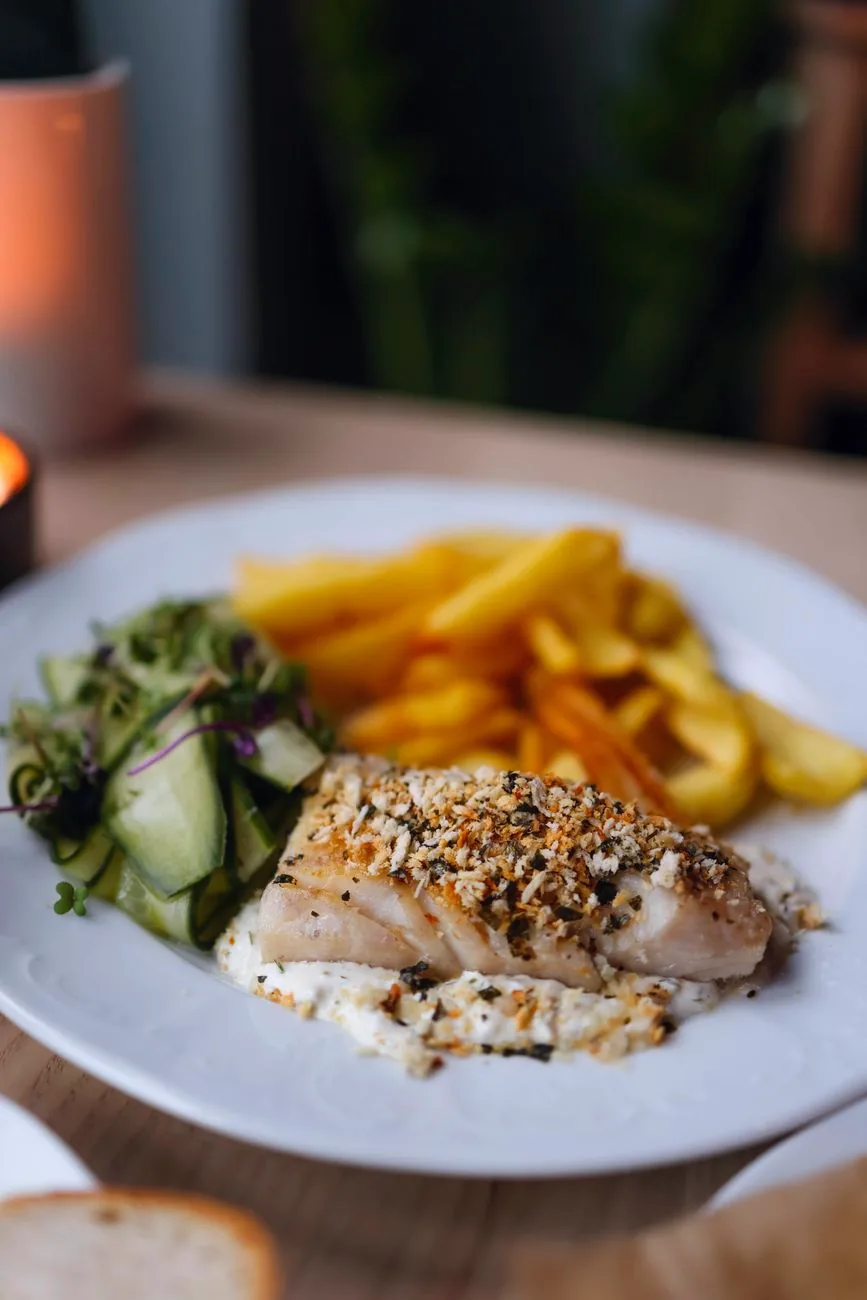 Crispy fish with golden chips and cucumber salad.