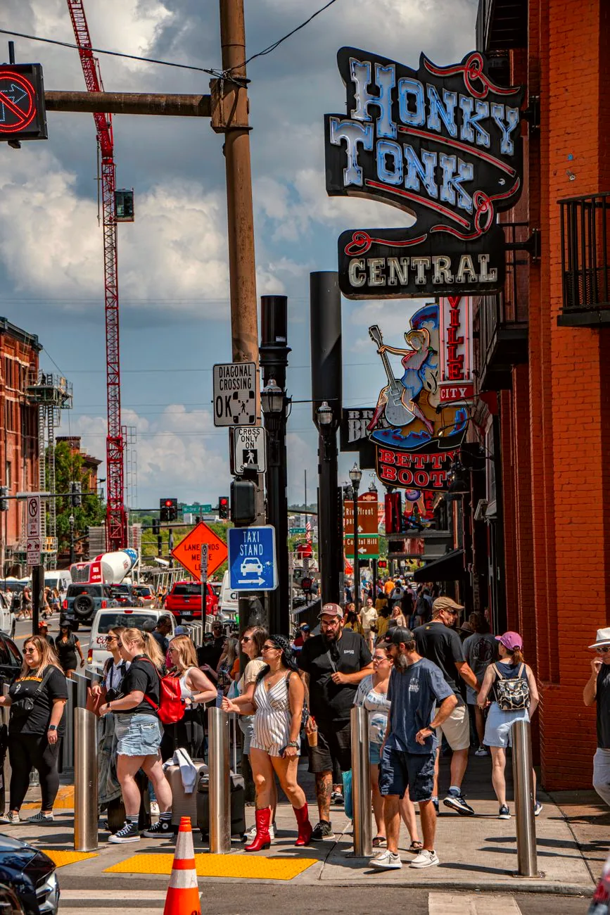 Crowds and illuminated signs along Lower Broadway in Nashville.