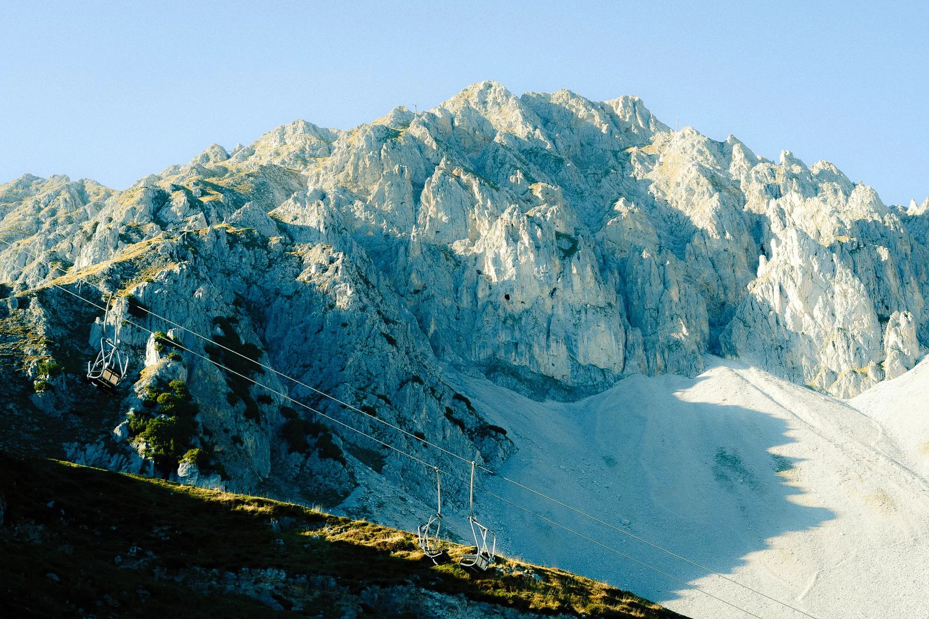 The Nordkette mountain range above Innsbruck, with cable cars crossing the slopes.