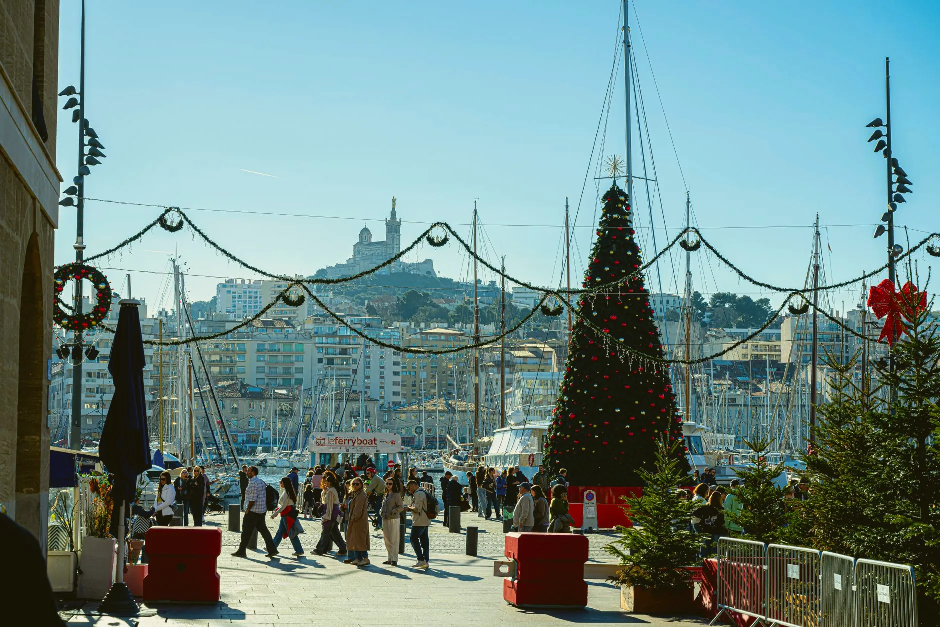 Christmas decorations with a view of Notre-Dame de la Garde above Marseille’s Vieux-Port.