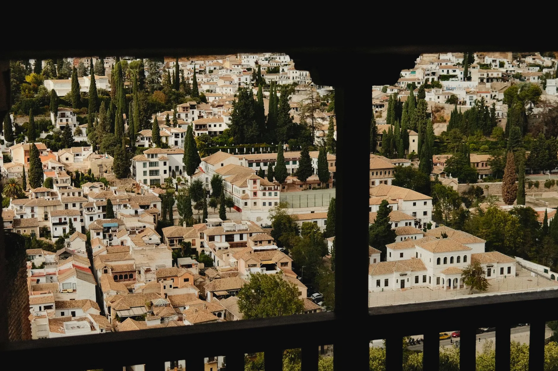 Whitewashed buildings and cypress trees across Granada’s Albaicín
