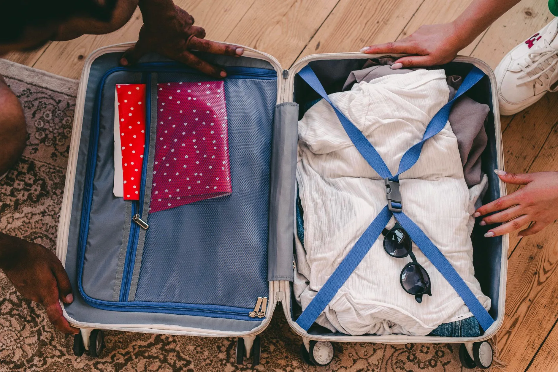 An open suitcase neatly packed with clothes and travel essentials.